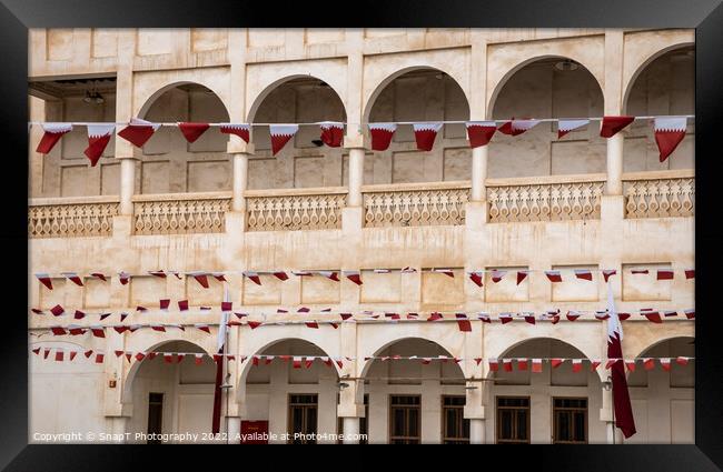 Rows of Al-Adaam national flags of Qatar flying in Souq Waqif, Doha, Qatar Framed Print by SnapT Photography