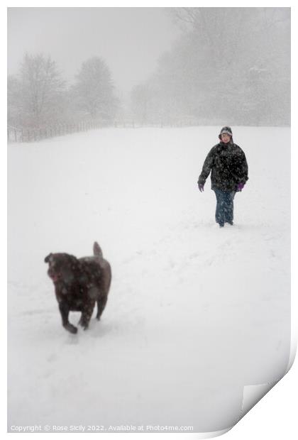 Person walking a dog in winter in snowy fields  Print by Rose Sicily