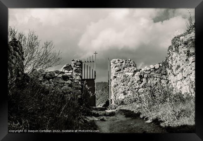 Scary entrance to an old stone cemetery with an iron gate. Framed Print by Joaquin Corbalan