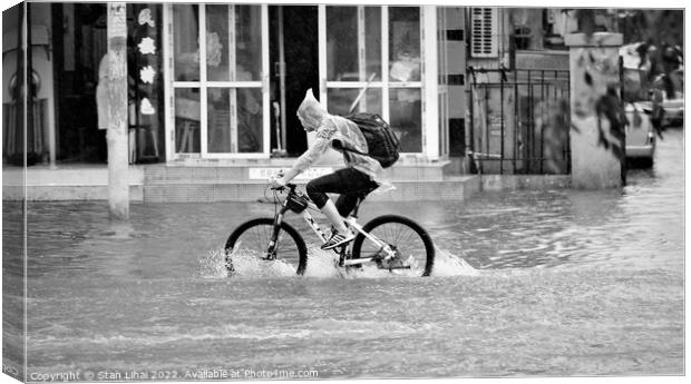 Person riding a bicycle under heavy rain Canvas Print by Stan Lihai