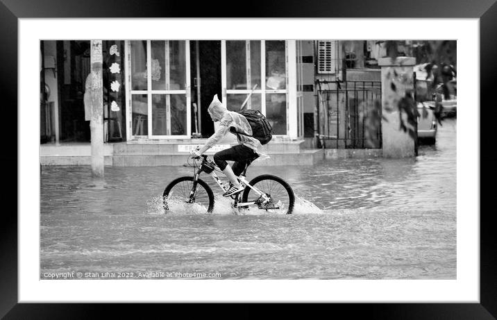 Person riding a bicycle under heavy rain Framed Mounted Print by Stan Lihai