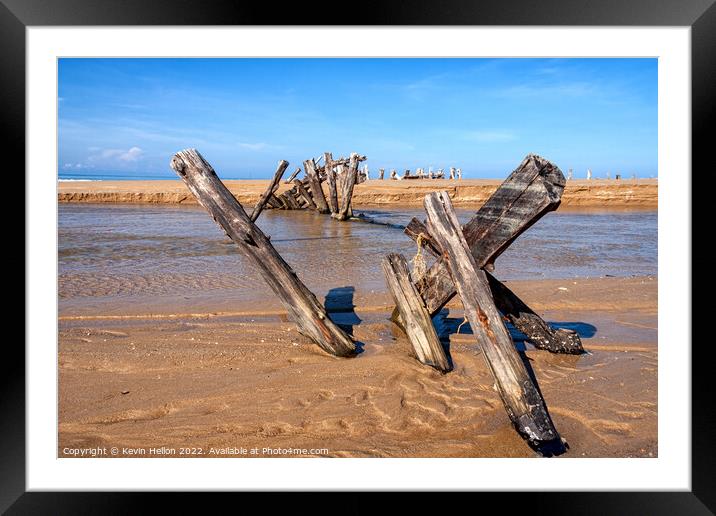 Posts in the sand Framed Mounted Print by Kevin Hellon