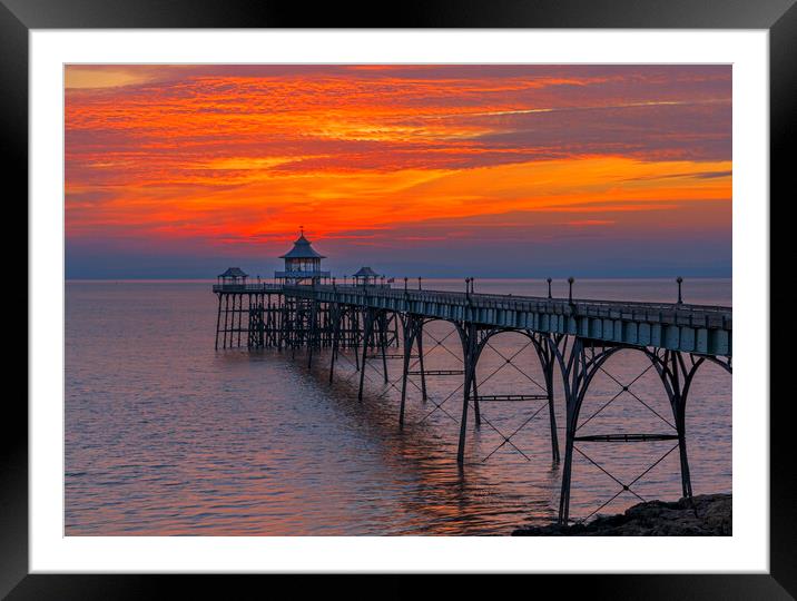 Clevedon Pier with brigh reddish orangey horizon Framed Mounted Print by Rory Hailes