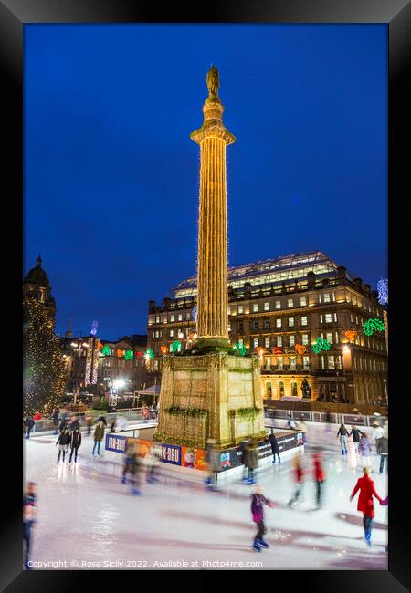 Ice skating at the Christmas funfair George Square Glasgow Scotland UK Framed Print by Rose Sicily