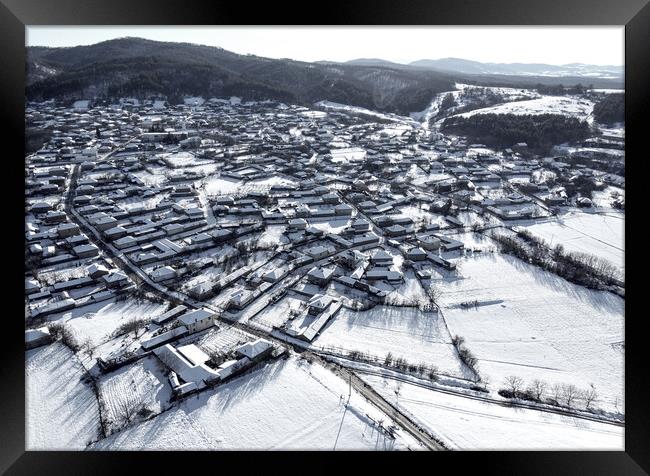 Snowbound village Framed Print by Martin Smith