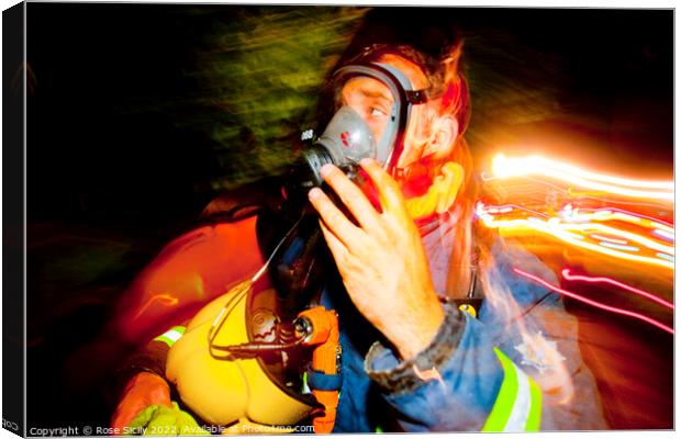 Firefighter in breathing apparatus and fire appliance with blurred lights at a fire Canvas Print by Rose Sicily