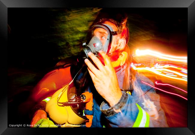 Firefighter in breathing apparatus and fire appliance with blurred lights at a fire Framed Print by Rose Sicily