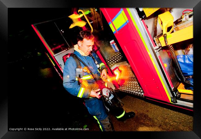Firefighter in breathing apparatus and fire appliance with blurred lights at a fire Framed Print by Rose Sicily