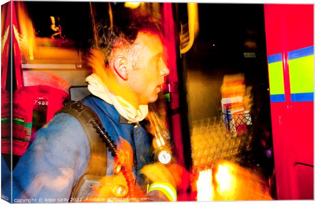 Firefighter in breathing apparatus and fire appliance with blurred lights at a fire Canvas Print by Rose Sicily