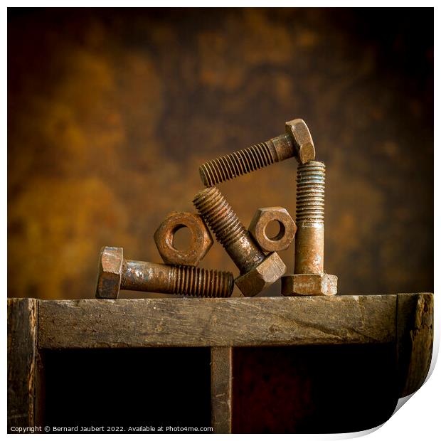 Rusty bolt on a wooden surafce Print by Bernard Jaubert