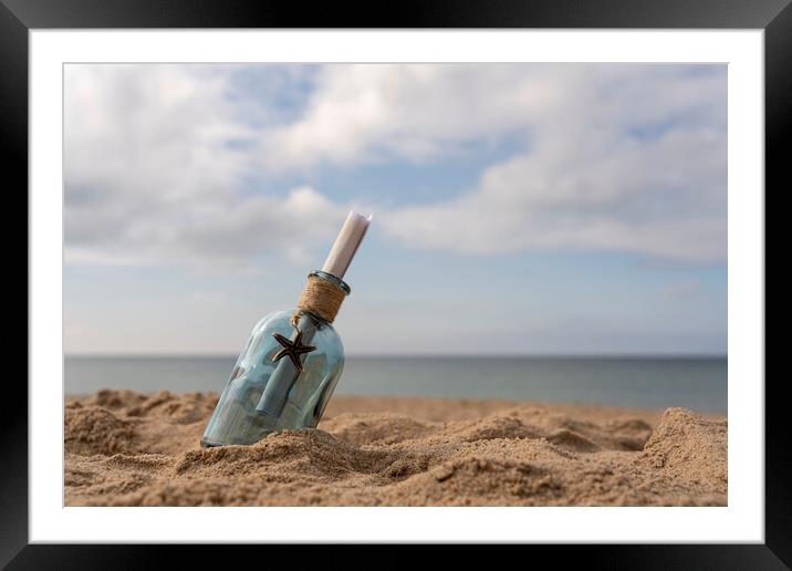 Message in a bottle on the sand Framed Mounted Print by Anthony Hart
