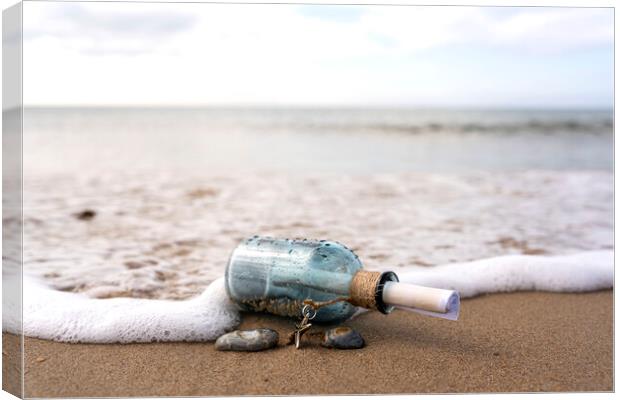 Message in a bottle in the surf Canvas Print by Anthony Hart