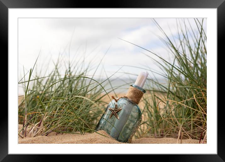 Message in a bottle in the dunes Framed Mounted Print by Anthony Hart