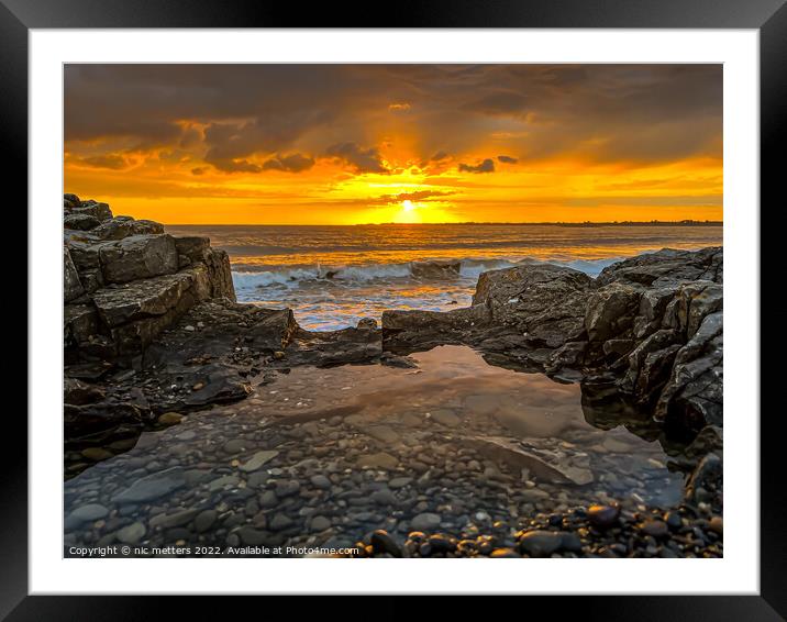 Sun setting over the sea Framed Mounted Print by nic 744