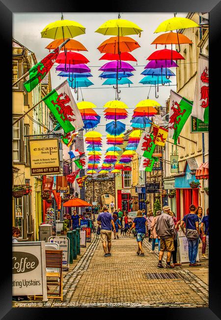 Umbrella Stroll in Caernarfon Framed Print by Ian Stone