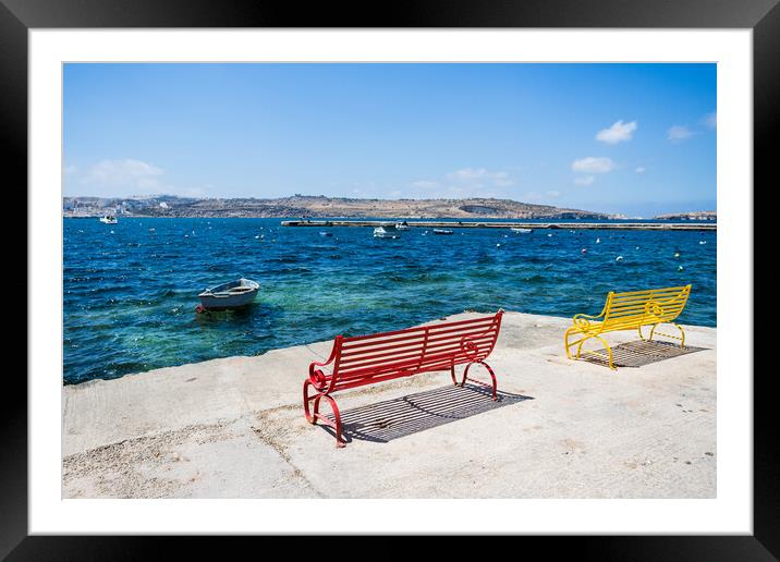 Red and yellow benches face out to sea Framed Mounted Print by Jason Wells