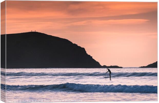 Evening light over a paddle boarder in Fistral Bay Canvas Print by Gordon Scammell