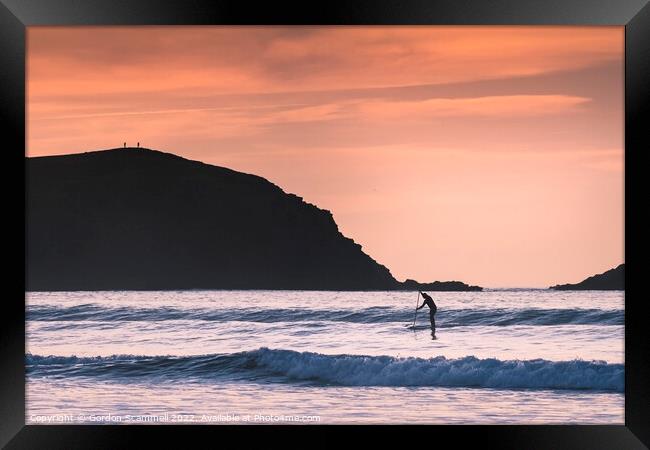 Evening light over a paddle boarder in Fistral Bay Framed Print by Gordon Scammell
