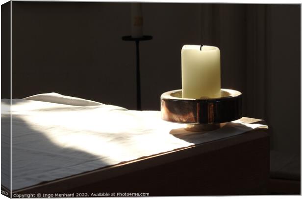 A closeup shot of a candle in the candle holder on the white cloth under the sunbeams Canvas Print by Ingo Menhard