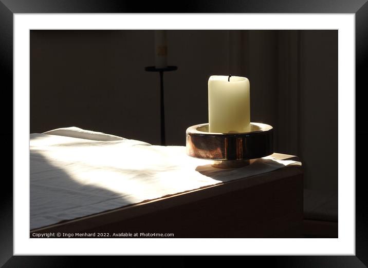 A closeup shot of a candle in the candle holder on the white cloth under the sunbeams Framed Mounted Print by Ingo Menhard