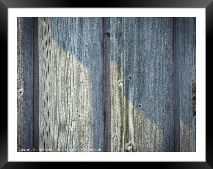 A closeup of a wooden wall background on a sunny day Framed Mounted Print by Ingo Menhard