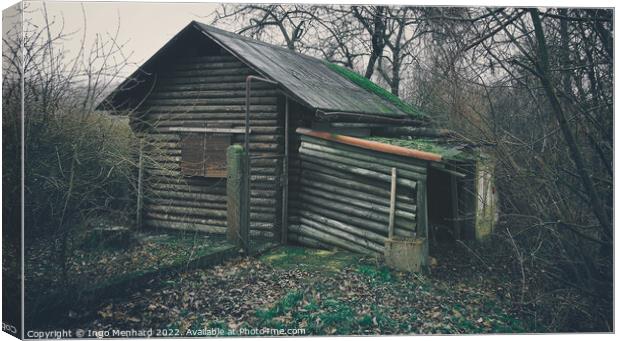 Old and weathered wooden house surrounded by trees in the woods Canvas Print by Ingo Menhard