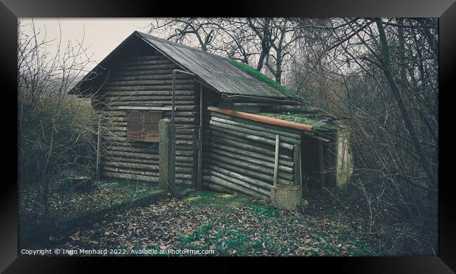 Old and weathered wooden house surrounded by trees in the woods Framed Print by Ingo Menhard