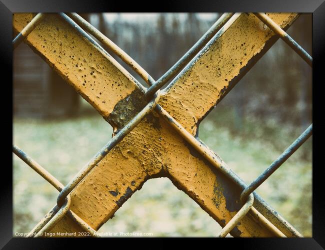 Old and weathered yellow-painted metal fence Framed Print by Ingo Menhard