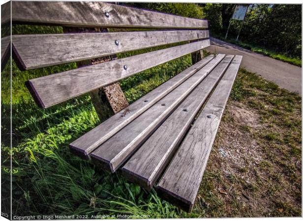 Closeup shot of a wooden bench near a road Canvas Print by Ingo Menhard