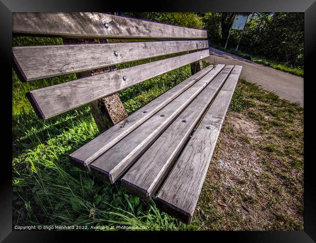 Closeup shot of a wooden bench near a road Framed Print by Ingo Menhard