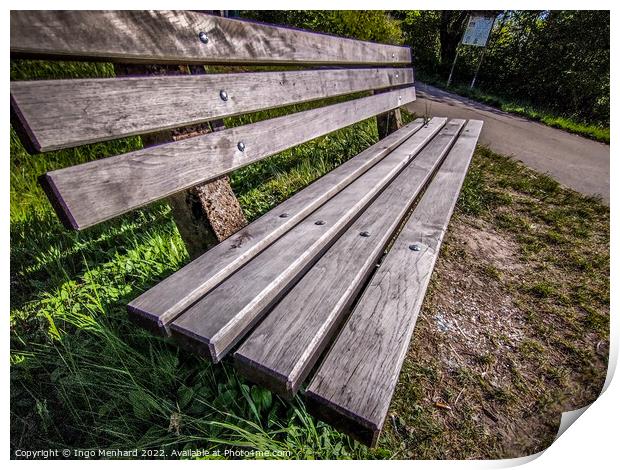 Closeup shot of a wooden bench near a road Print by Ingo Menhard