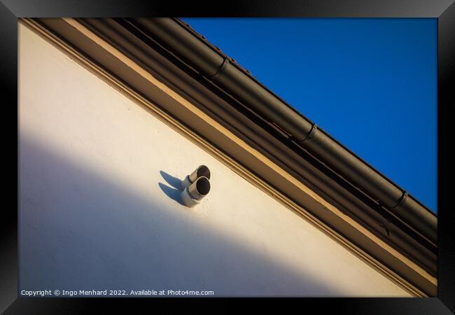 Low angle shot of a surveillance camera on a building Framed Print by Ingo Menhard