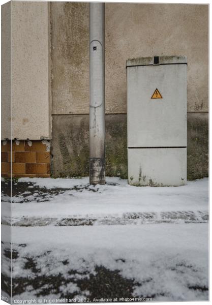 Vertical of an electricity control box on the snowy road Canvas Print by Ingo Menhard
