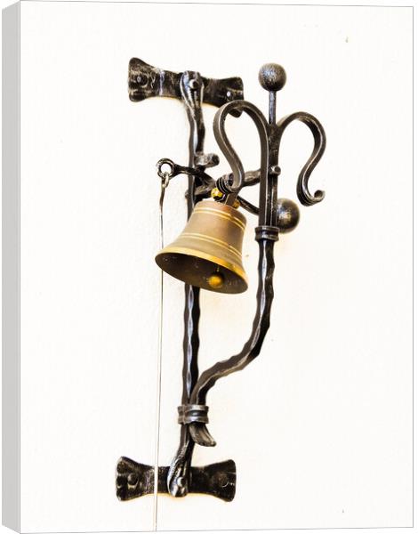 A vertical shot of a bell hung on the forged metal isolated on white background Canvas Print by Ingo Menhard