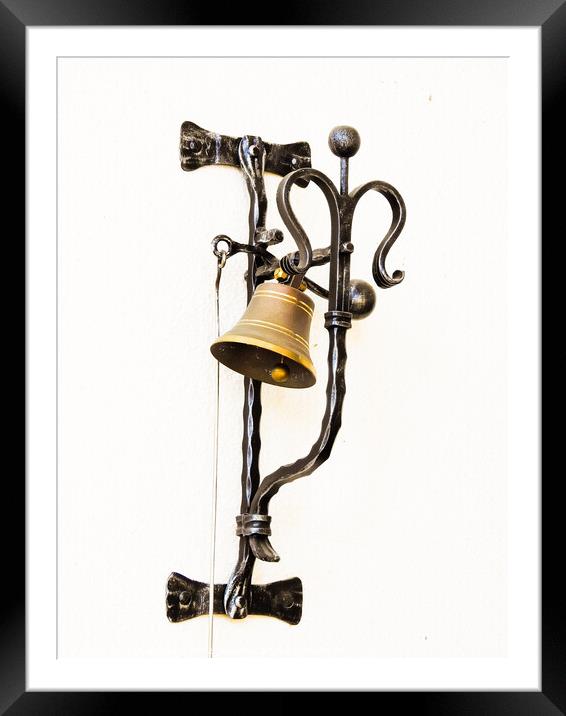 A vertical shot of a bell hung on the forged metal isolated on white background Framed Mounted Print by Ingo Menhard