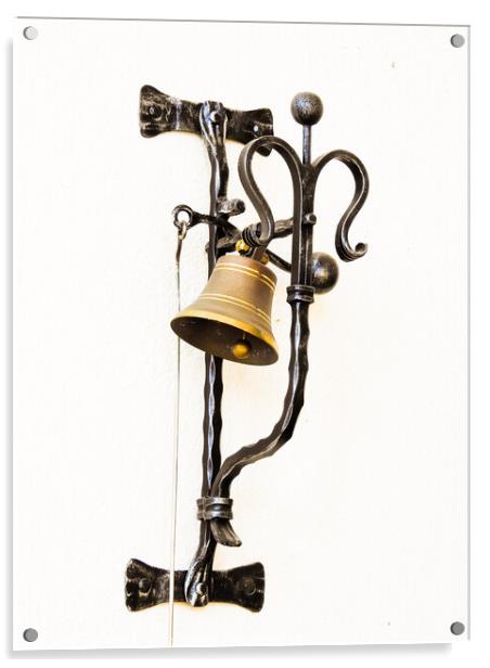 A vertical shot of a bell hung on the forged metal isolated on white background Acrylic by Ingo Menhard