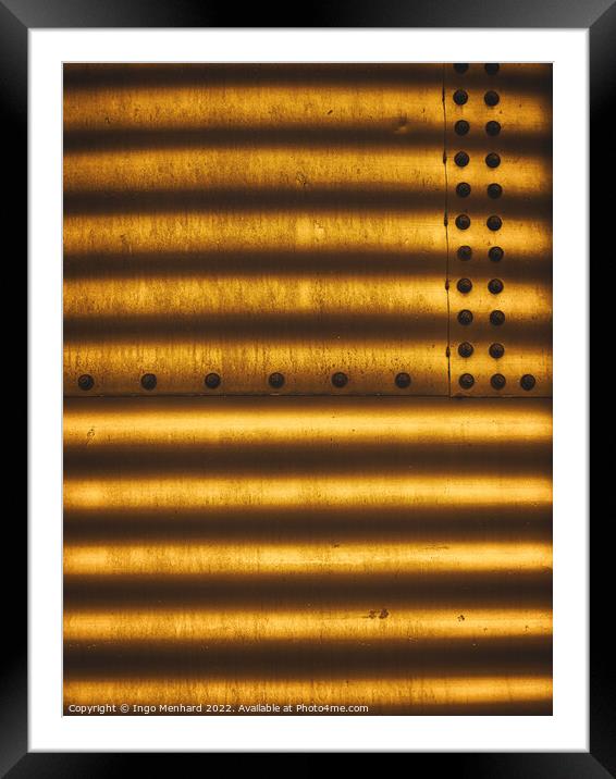 Golden metal texture with lined shadows from blinds attached with screw fasteners Framed Mounted Print by Ingo Menhard