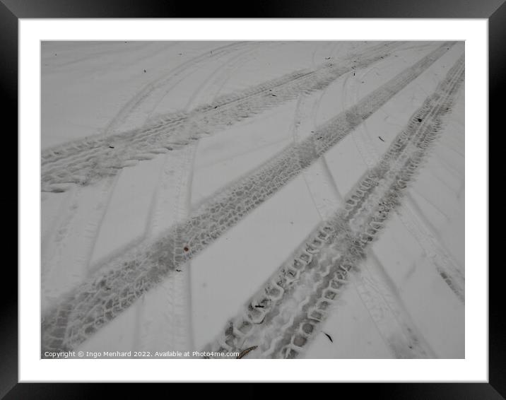 Closeup of the tire marks on the snowy road Framed Mounted Print by Ingo Menhard