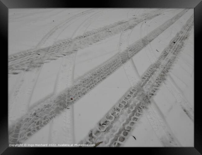 Closeup of the tire marks on the snowy road Framed Print by Ingo Menhard