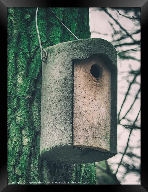 Vertical shot of a cylindrical concrete nesting box hanging from a tree Framed Print by Ingo Menhard