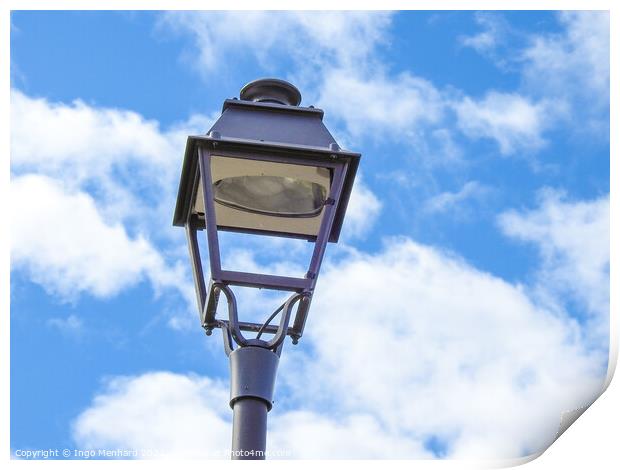 A low angle shot of an old metal street lamp against blue cloudy sky Print by Ingo Menhard