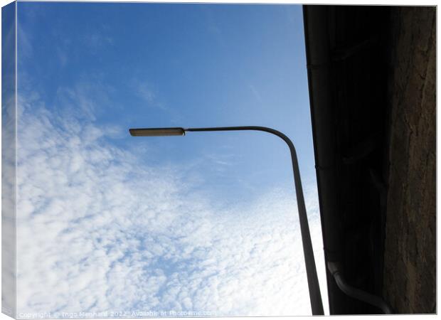 A low angle shot of a street light on a cloudy sky background Canvas Print by Ingo Menhard