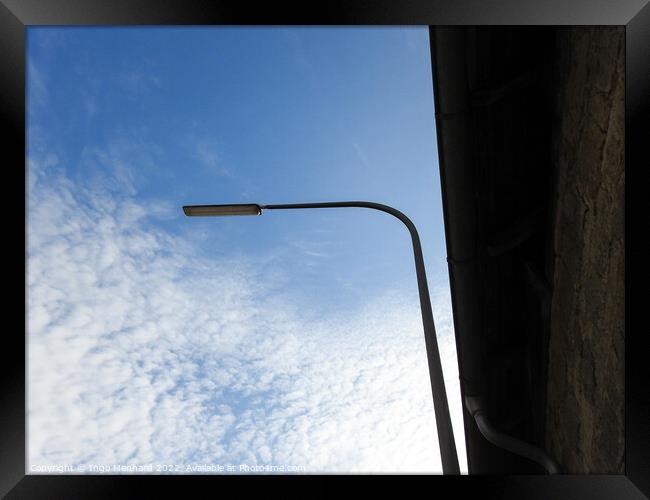A low angle shot of a street light on a cloudy sky background Framed Print by Ingo Menhard