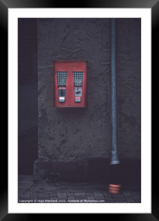 Old classic gumball machine beside a gutter Framed Mounted Print by Ingo Menhard