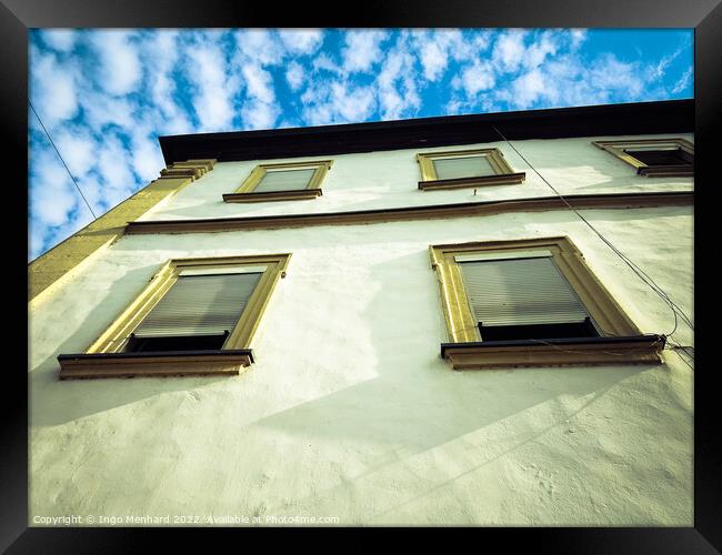 A low angle view of a building under a blue cloudy sky Framed Print by Ingo Menhard