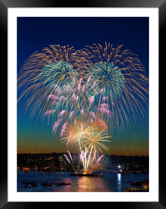 First launch of colorful fireworks right at sunset  Framed Mounted Print by Thomas Baker