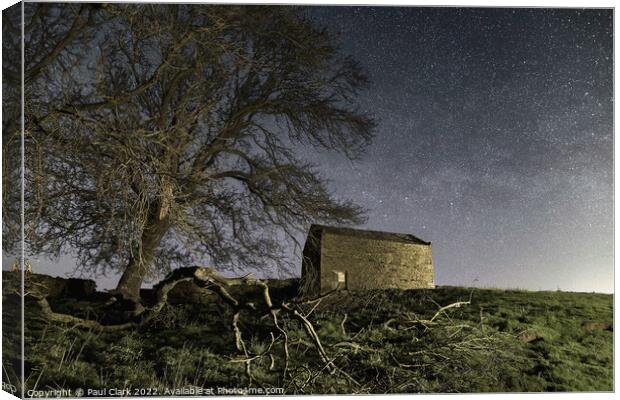 Swaledale barn and trees under the stars Canvas Print by Paul Clark
