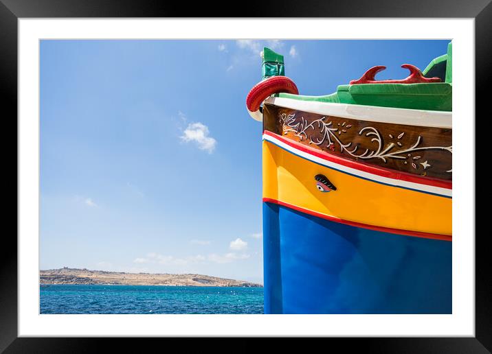 Luzzu boat next to the blue water Framed Mounted Print by Jason Wells