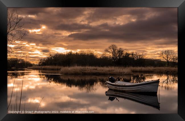 Sunset reflecting over the River Dee in Winter, with a boat in the river Framed Print by SnapT Photography