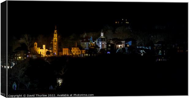 The lights of the Italianate village of Portmeirion illuminate the surrounding trees Canvas Print by David Thurlow
